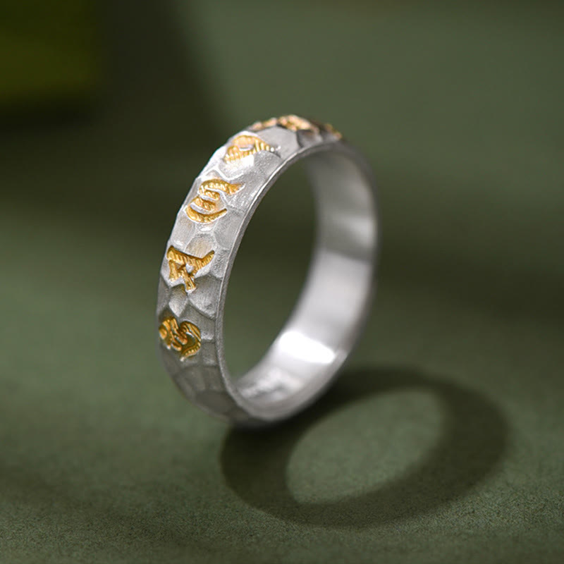 Hammered Om Mani Padme Hum Ring - angled view showing four gold Sanskrit characters, artisan mantra band