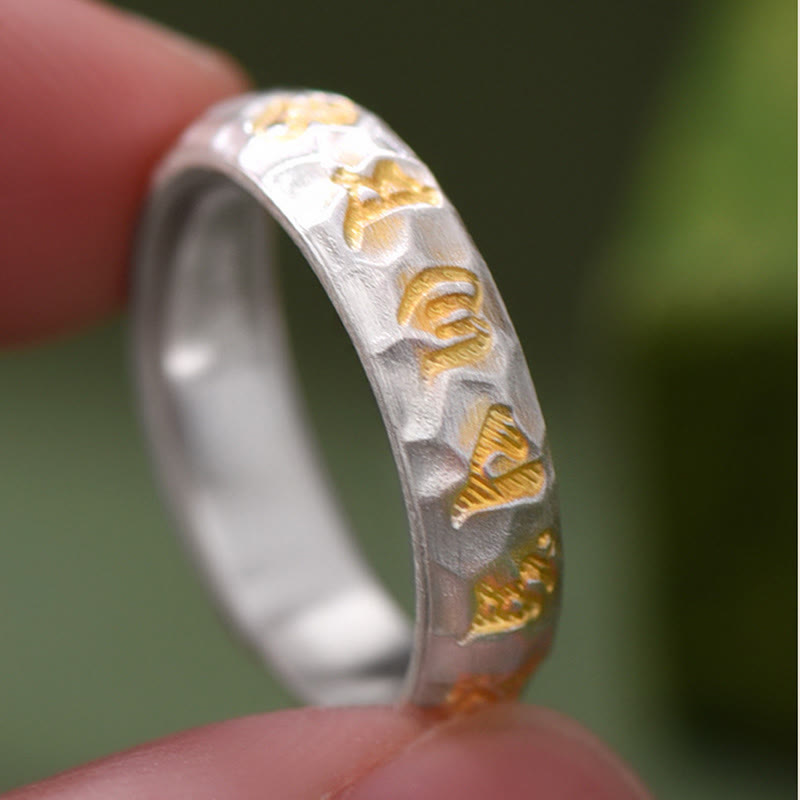 Hammered Om Mani Padme Hum Ring - outdoor macro shot gold script on silver, nature inspired ring