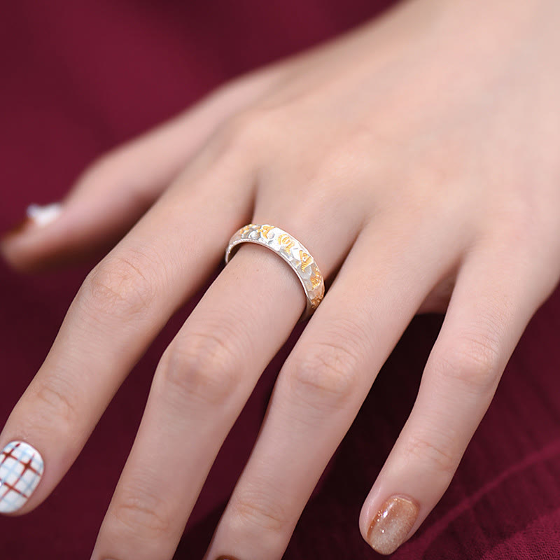 999 Silver Hammered Om Ring – Worn on finger against burgundy velvet, gold silver two-tone band