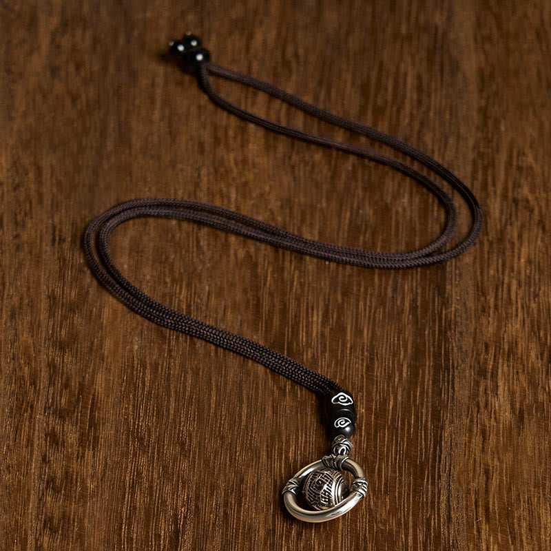 Om Mani Padme Hum Pendant – Top-down view on wood showing full cord necklace with cloud-motif beads, spiritual necklace
