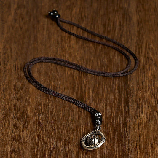 Om Mani Padme Hum Pendant – Top-down view on wood showing full cord necklace with cloud-motif beads, spiritual necklace