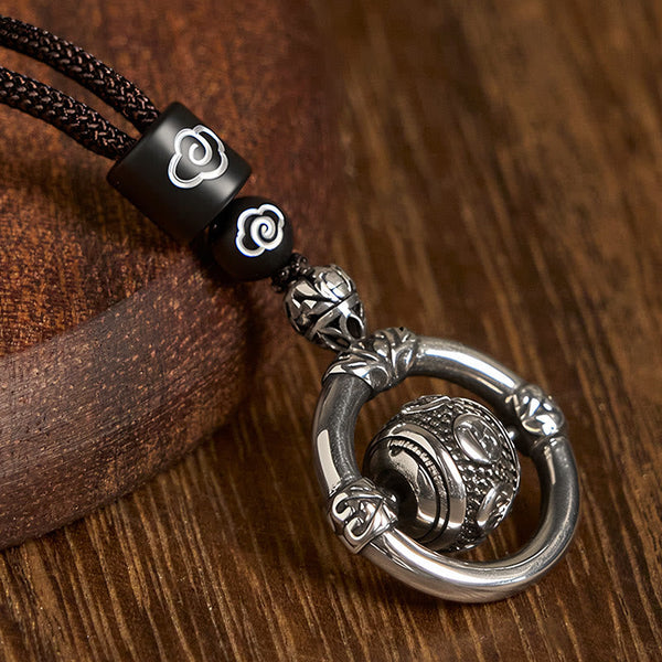 Om Mani Padme Hum Pendant – Three-quarter view on rustic wood showcasing metalwork and bead arrangement, Tibetan jewelry