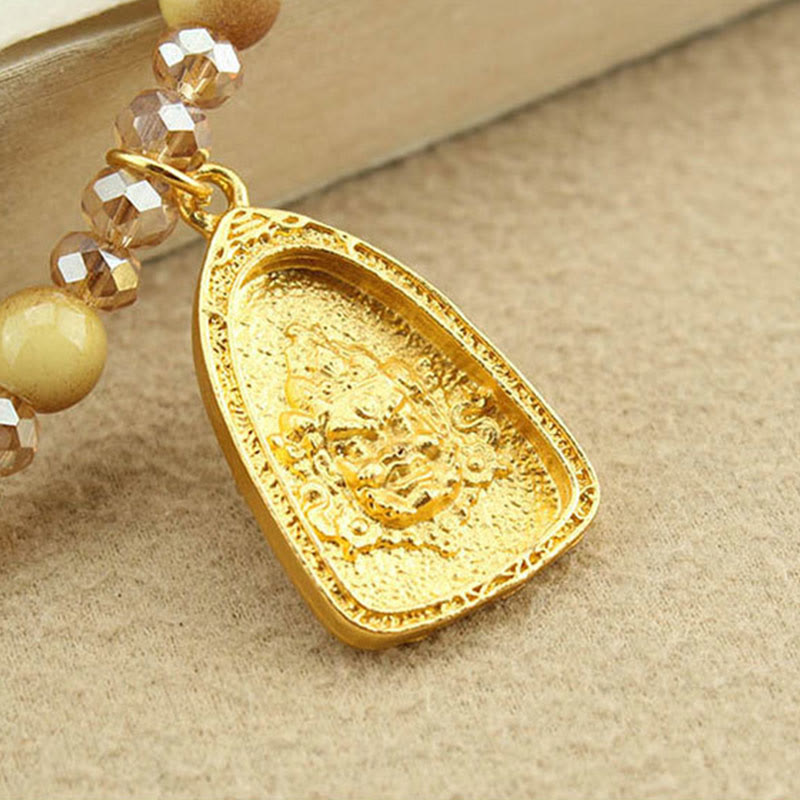 Tibetan Buddha Amulet Pendant – teardrop gold charm on crystal beads, courage