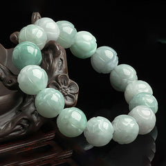 Jade Lotus Carving Prosperity Bracelet – green carved beads on floral wood stand, jade jewelry