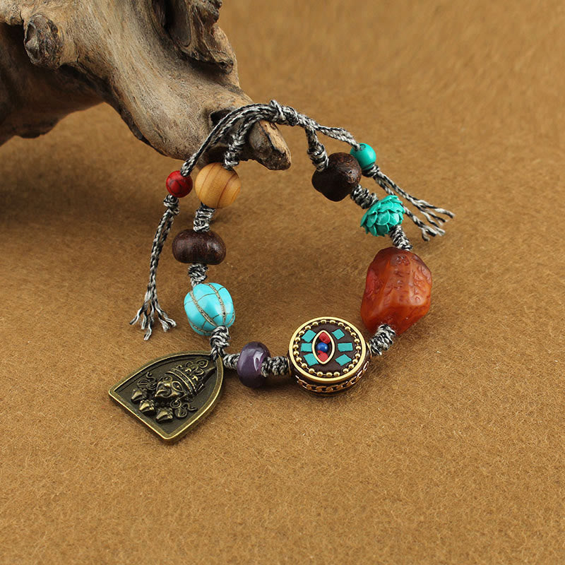 Tibetan Zakiram Turquoise Lotus Rope Bracelet – cord bracelet with turquoise and amber beads draped on driftwood, Boho