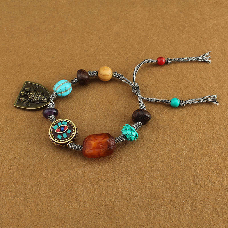 Tibetan Zakiram Turquoise Lotus Rope Bracelet – top-down cord bracelet with carved turquoise and amber focal stone, Rope Bracelet