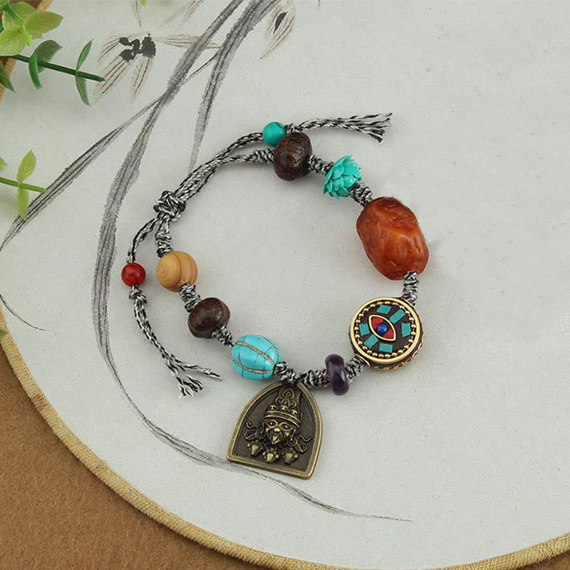Tibetan Zakiram Turquoise Lotus Rope Bracelet – cord bracelet styled with green leaf sprigs on fabric mat, Lotus