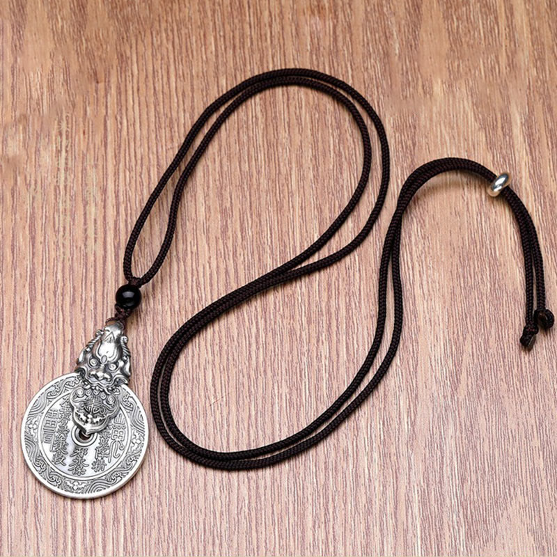 Mountain Ghost Bagua Copper Pixiu Necklace – full cord layout light wood background, adjustable necklace length