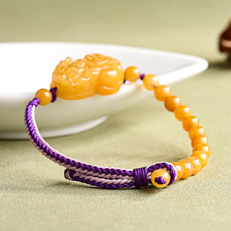Golden Silk Jade PiXiu Wealth Bracelet – braided purple cord detail with bowl, jade wealth charm
