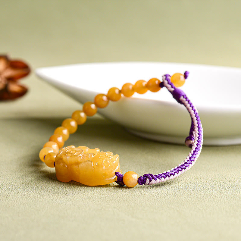 Golden Silk Jade PiXiu Wealth Bracelet – alternate flat lay on green cloth, golden jade fortune accessory