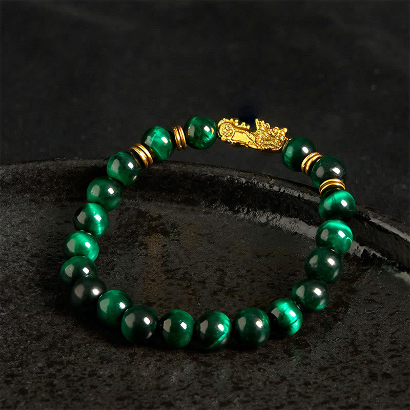 Multi-Color Tiger Eye PiXiu bracelet – green tiger eye beads with gold PiXiu on dark stone, feng shui