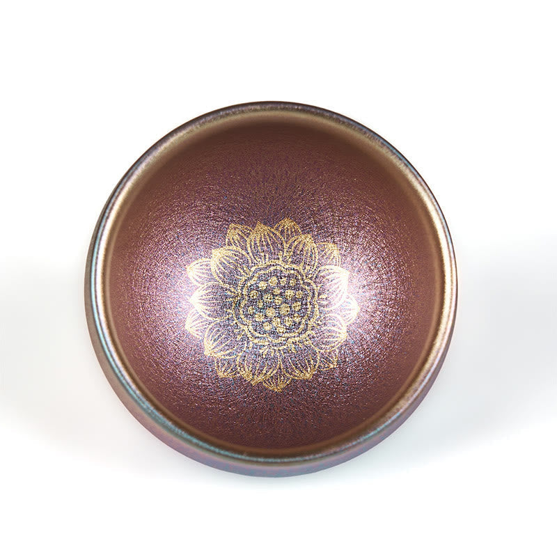 Golden Lotus Ceramic Tea Cup – copper metallic glaze with gold lotus overhead, white background, Jianzhan
