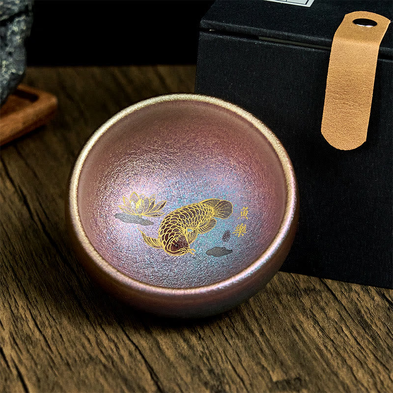 Jianzhan Koi Fish Lotus Teacup – overhead shot of cup in gift box, iridescent glaze, gold koi interior, luxury packaging