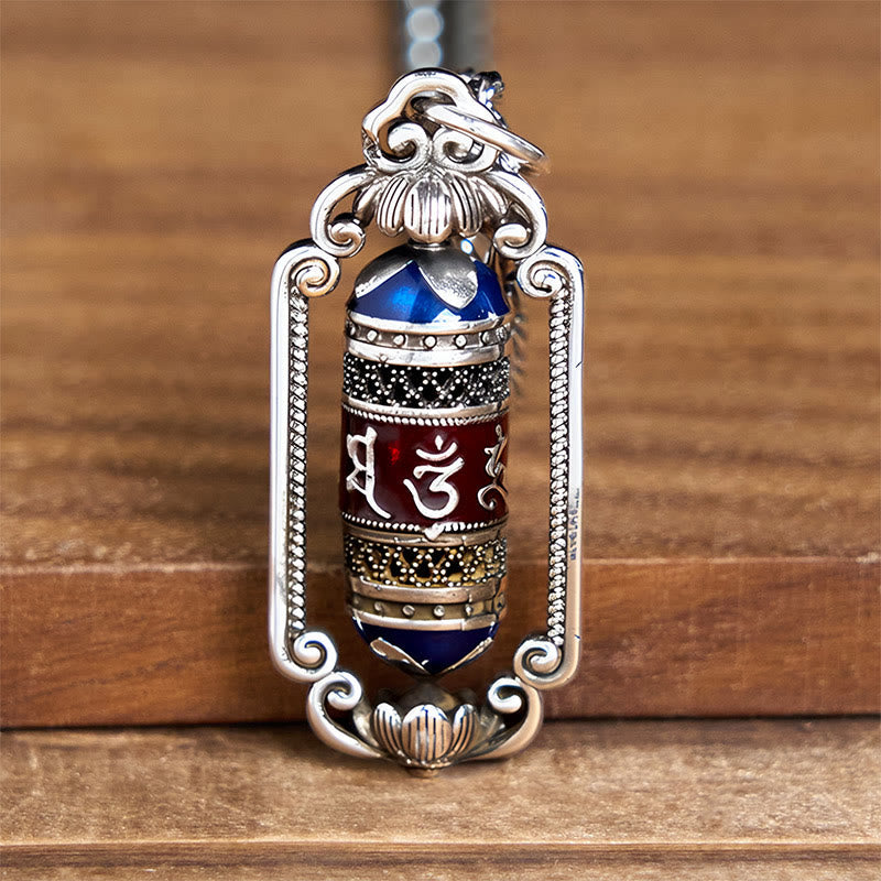 Om Mani Padme Hum Prayer Wheel Pendant – Close-up on cobalt blue enamel caps and silver filigree borders of Buddhist praye...