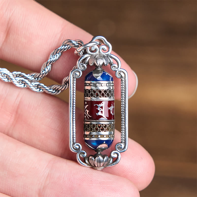 Om Mani Padme Hum Prayer Wheel Pendant – Three-quarter hand view revealing cylindrical depth and beaded frame texture, men...