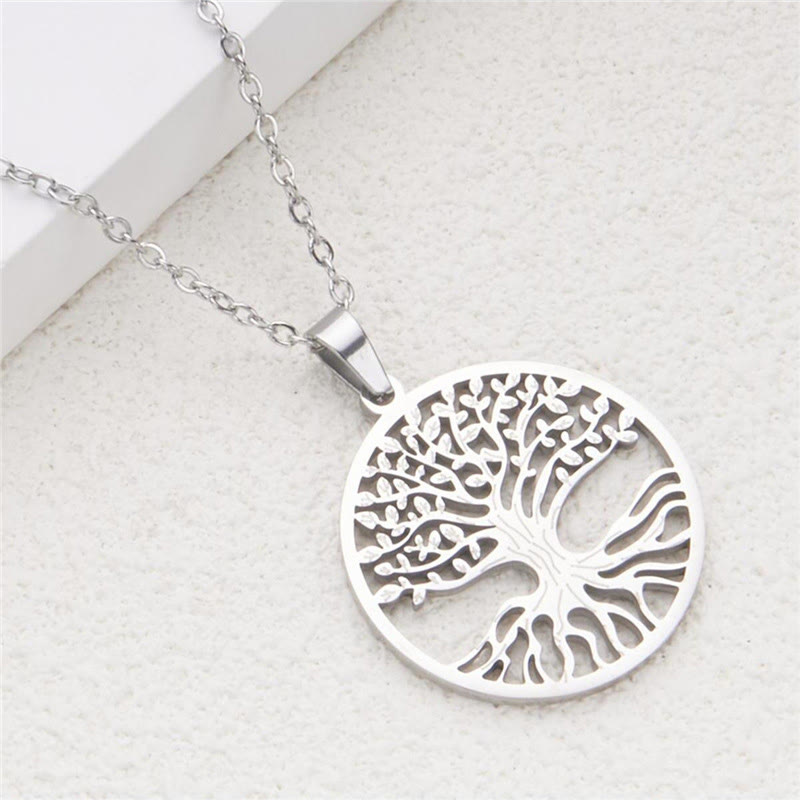 Tree of Life Titanium Steel Necklace – silver-tone pendant on light stone surface, elevated diagonal view