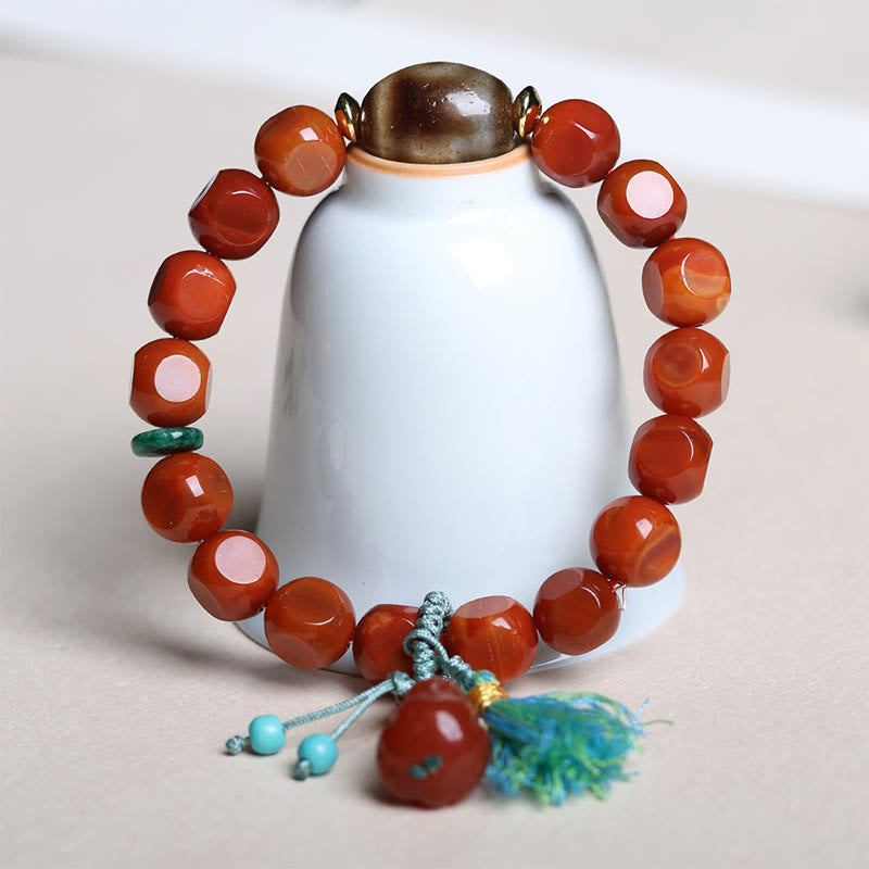 South Red Agate Dzi Bead PiXiu Bracelet – displayed on white ceramic vase, elegant feng shui accessory