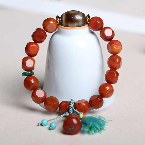 South Red Agate Dzi Bead PiXiu Bracelet – displayed on white ceramic vase, elegant feng shui accessory