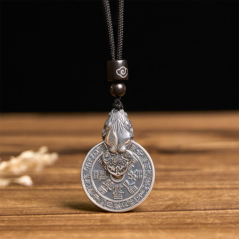 Mountain Ghost Bagua Copper Pixiu Necklace – front view black background wooden surface, copper feng shui pendant