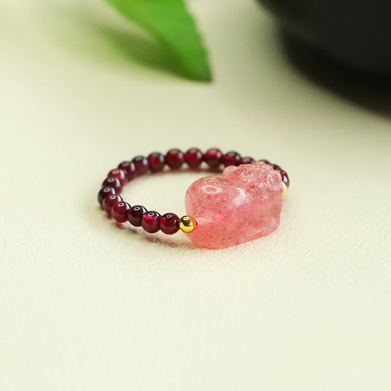 Garnet Strawberry Quartz Pixiu Ring – side angle green leaf background pink pixiu garnet beads, healing jewelry