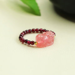 Garnet Strawberry Quartz Pixiu Ring – side angle green leaf background pink pixiu garnet beads, healing jewelry