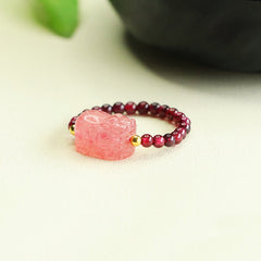 Garnet Strawberry Quartz Pixiu Ring – angled view cream background pink pixiu garnet gold beads, love ring