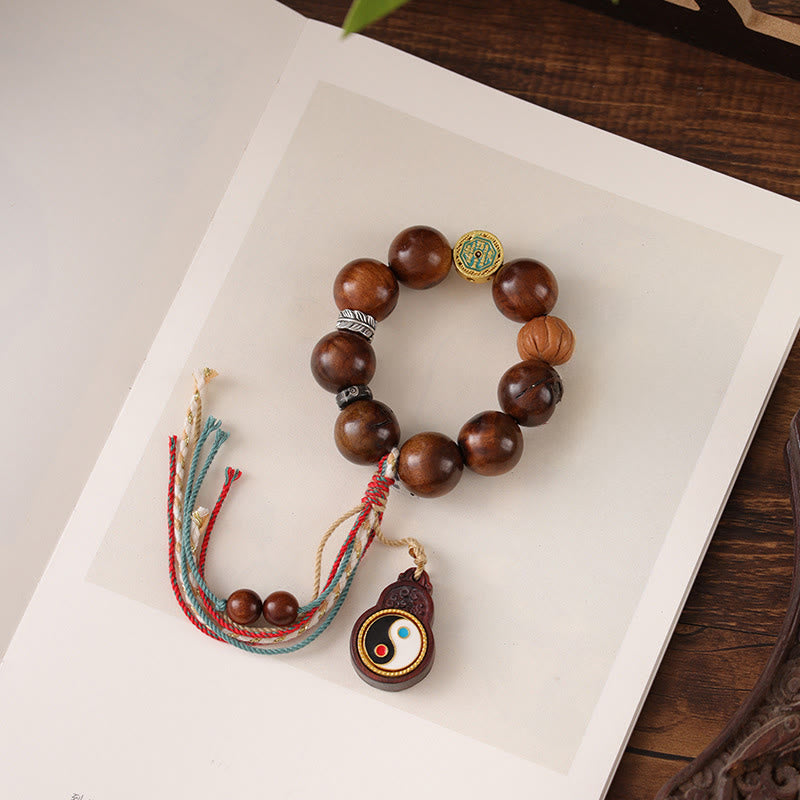 Tibet Jujube Wood Yin Yang Bracelet – circular arrangement on white with green leaf accent, carved wood beads and colorful...
