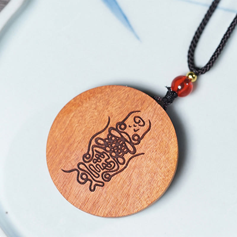 Jujube Wood Yin Yang Bagua Necklace – Engraved wooden pendant necklace on blue ceramic plate, artisan Taoist talisman jewelry