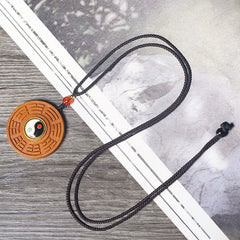 Jujube Wood Yin Yang Bagua Necklace – Bagua yin-yang wooden pendant on ink wash painting background, Taoist protection nec...