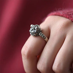 Copper Coin Pixiu Feng Shui Ring – worn on finger red fabric background, pixiu copper coin luck jewelry
