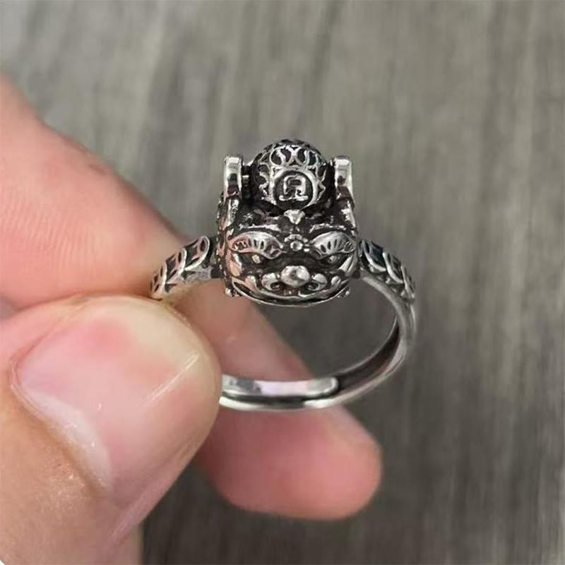 Copper Coin Pixiu Feng Shui Ring – hand holding ring wooden background top view coin, feng shui talisman