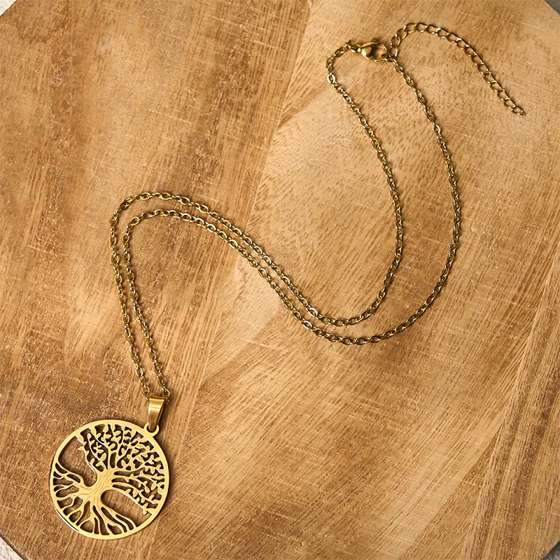 Tree of Life Titanium Steel Necklace – gold necklace flat lay on light wood showing full chain, overhead