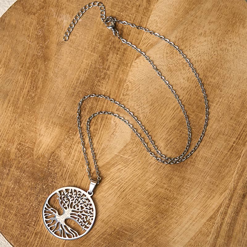 Tree of Life Titanium Steel Necklace – silver necklace flat lay on warm wood showing clasp and extender