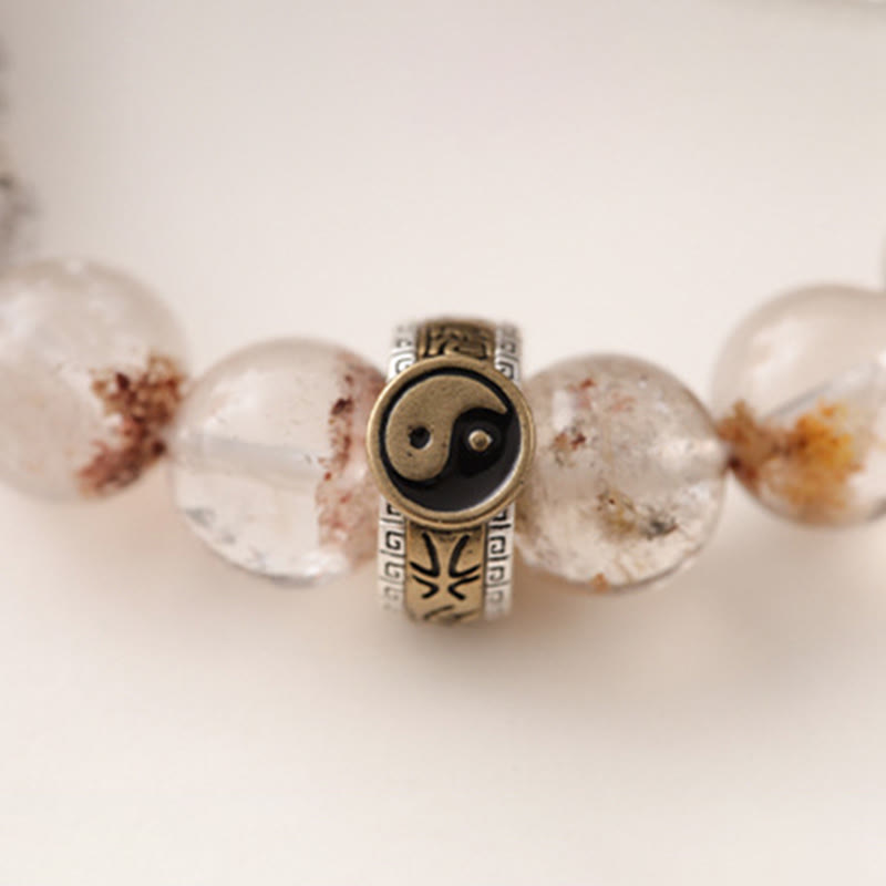 Lightning Struck Wood Red Phantom Bracelet – close-up of antique silver yin-yang charm bead with engraved geometric patter...