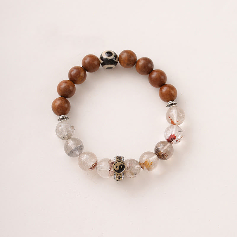 Lightning Struck Wood Red Phantom Bracelet – top-down view on off-white background, dzi bead and crystal with yin-yang spa...