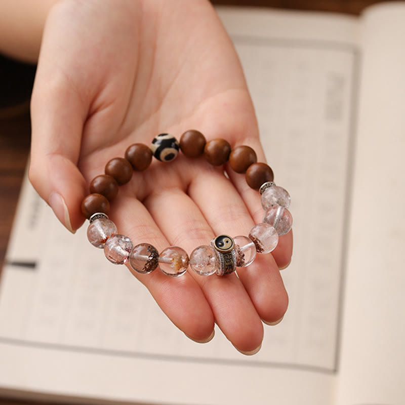 Lightning Struck Wood Red Phantom Bracelet – bracelet resting in open hand with open book background, natural stone wellne...