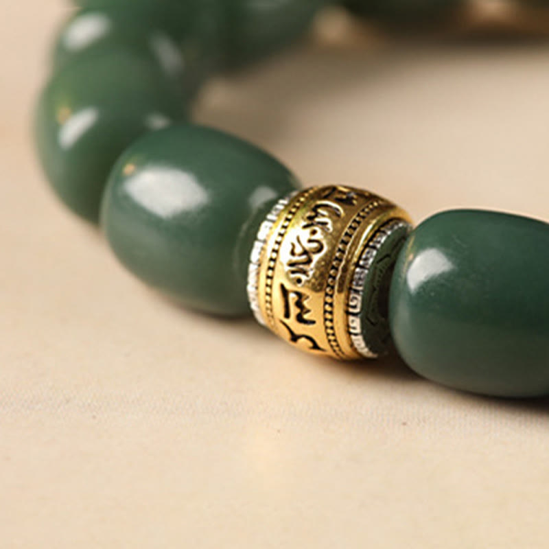Bodhi Seed Lion Head Om Mani Padme Hum Bracelet - gold mantra bead close-up, tibetan prayer bracelet