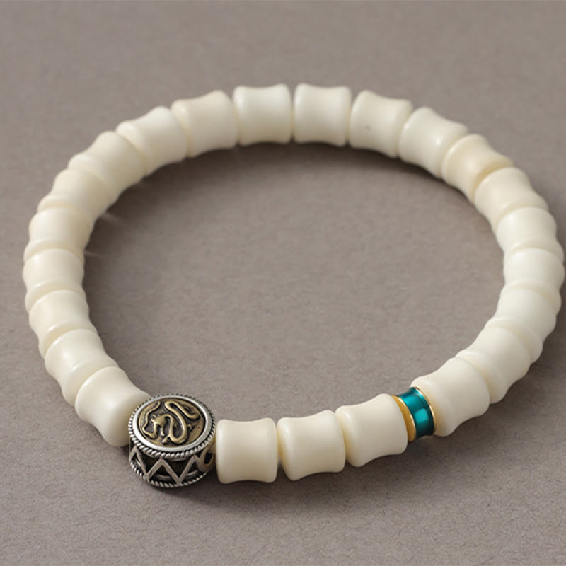 Bodhi Seed Dragon Pattern Bracelet – close-up Om symbol bead with chevron metalwork, Wisdom