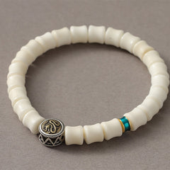 Bodhi Seed Dragon Pattern Bracelet – close-up Om symbol bead with chevron metalwork, Wisdom
