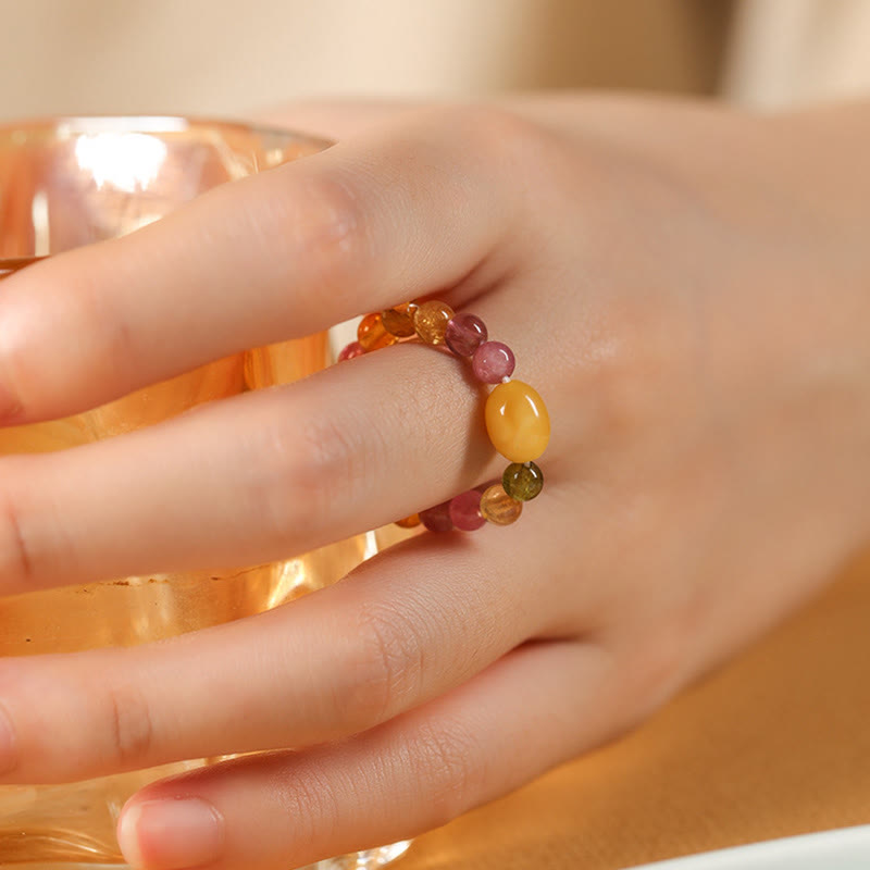 Tourmaline Pearl Amber Pixiu Ring – finger holding amber glass yellow amber bead, feng shui wealth ring