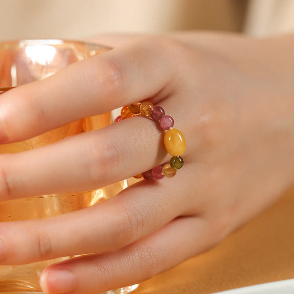 Tourmaline Pearl Amber Pixiu Ring – finger holding amber glass yellow amber bead, feng shui wealth ring