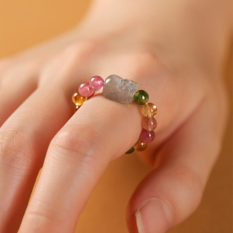 Tourmaline Pearl Amber Pixiu Ring – close-up finger warm golden background, pixiu gemstone wealth ring