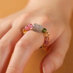 Tourmaline Pearl Amber Pixiu Ring – close-up finger warm golden background, pixiu gemstone wealth ring
