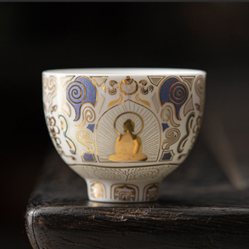 White Thangka Buddha Kung Fu Tea Cup – front view on dark wooden stand, gold Buddha with halo on white porcelain, studio shot