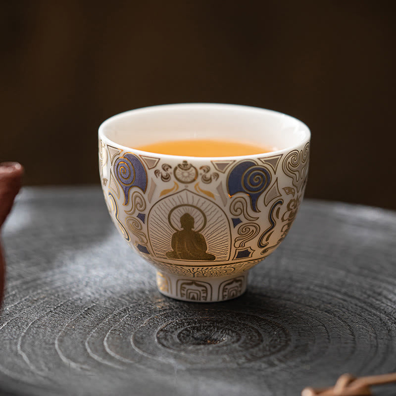 White Thangka Buddha Kung Fu Tea Cup – filled with golden tea on stone tea tray, warm light, peaceful tea ceremony moment