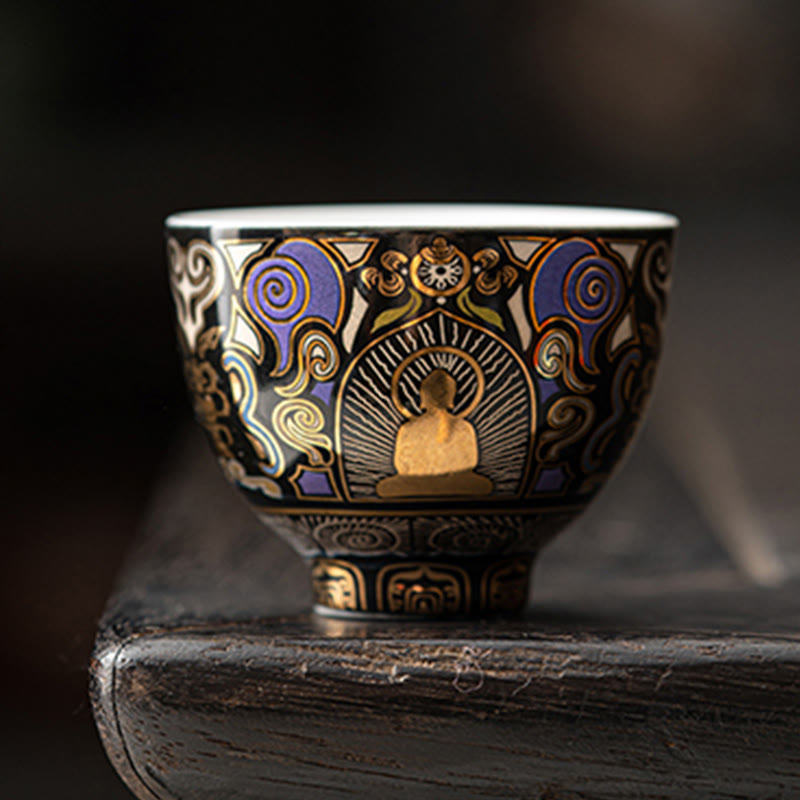 Black Thangka Buddha Kung Fu Tea Cup – front view on dark wooden stand, gold Buddha with radiant halo on black glaze, studio shot