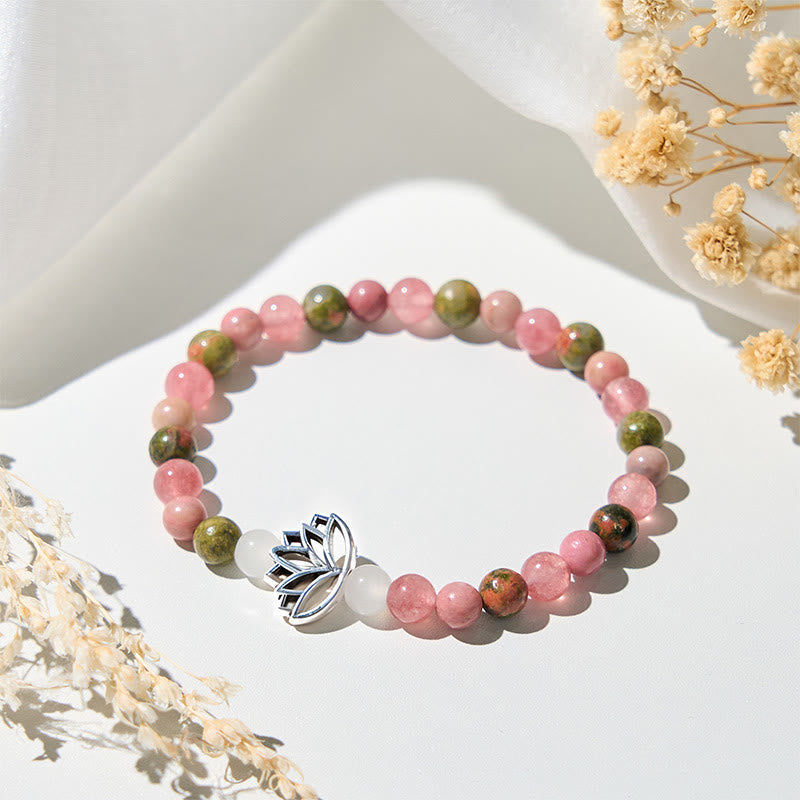 Natural pink quartz and green unakite stretch bracelet with silver lotus charm on white linen, gemstone jewelry