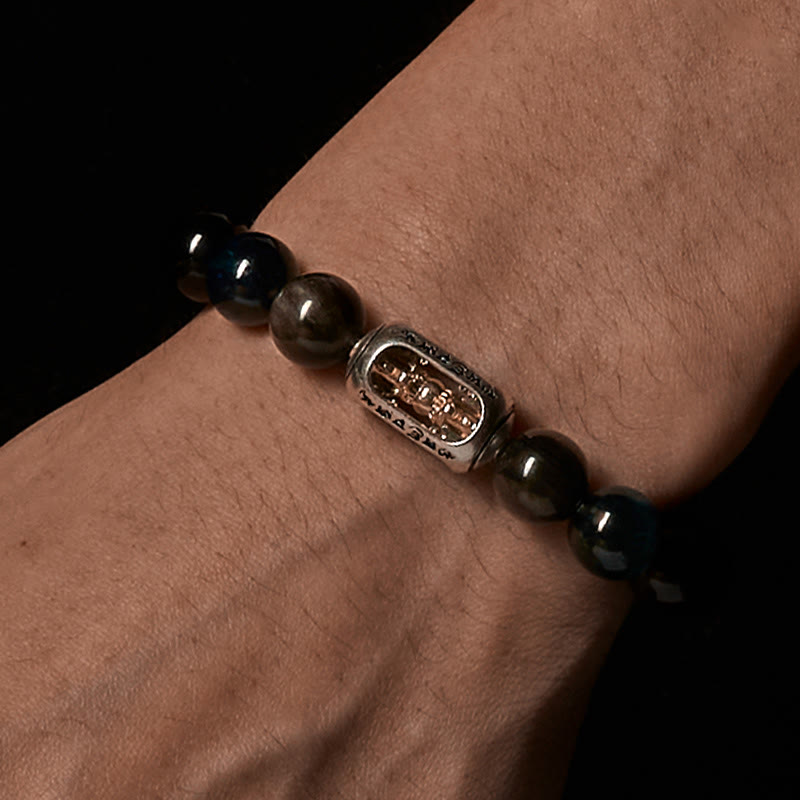 Silver Sheen Obsidian Bracelet worn on wrist - black background, two-tone silver gold charm with Buddha figure, mens protection jewelry
