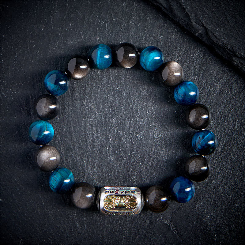 Silver Obsidian Blue Tiger Eye Bracelet - top-down on dark stone, alternating blue black beads with gold pixiu charm, mens energy bracelet