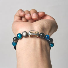 Silver Sheen Obsidian Blue Tiger Eye Bracelet on wrist - clean background, Om Mani Padme Hum charm with gold accents, mens meditation jewelry
